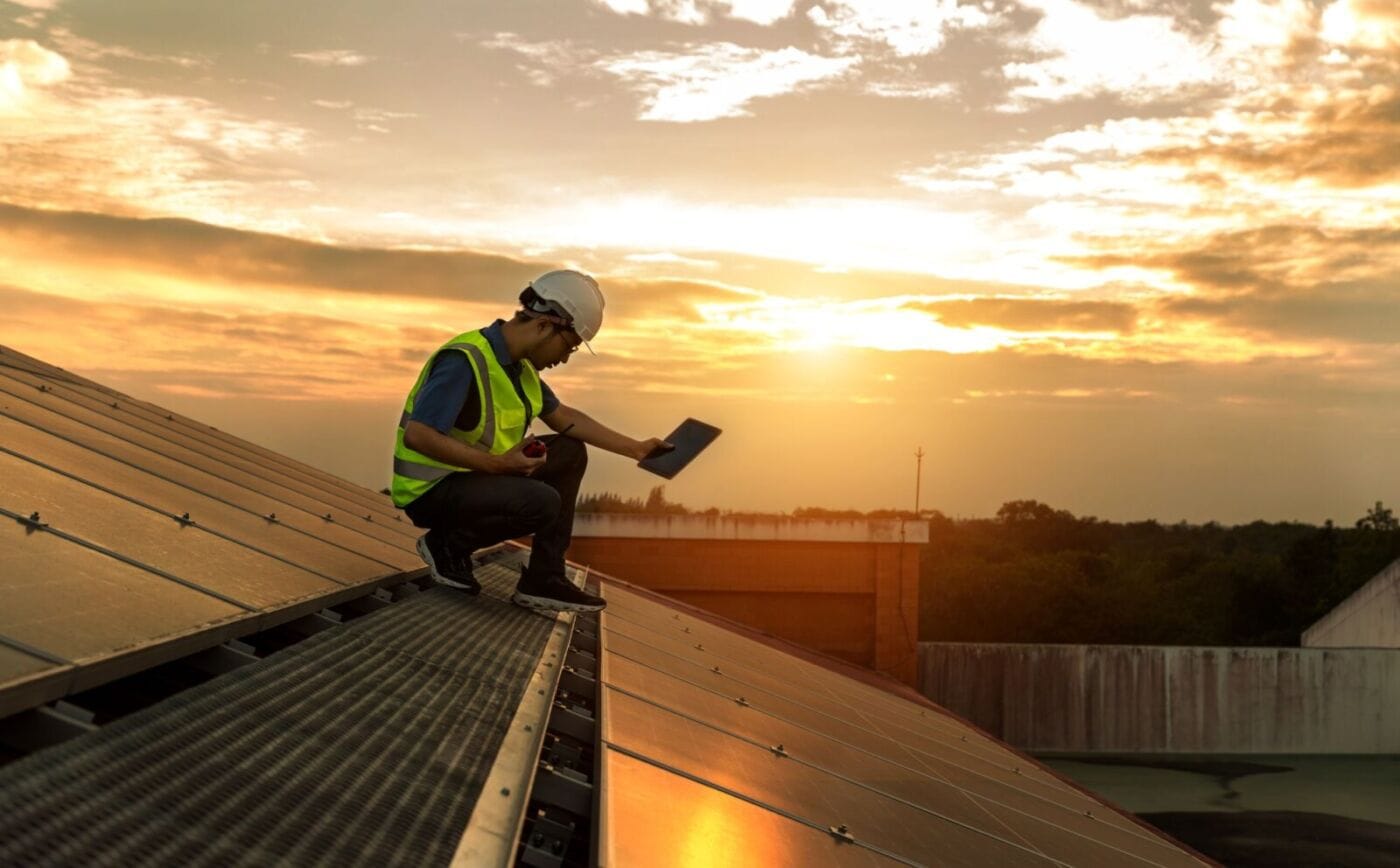 Engineer working setup Solar panel at the roof top.