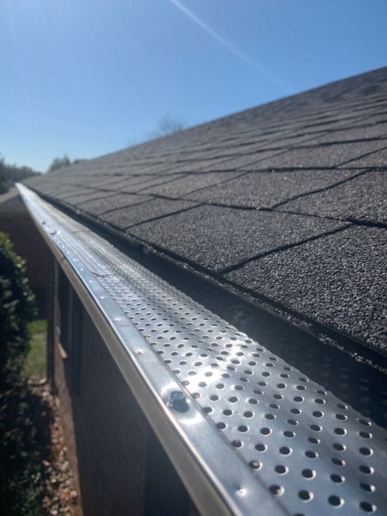 Roof of a house showing gutter and gutter guard protection against leaves Home maintenance
