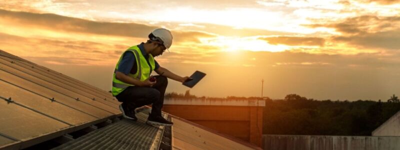 Engineer working setup Solar panel at the roof top.