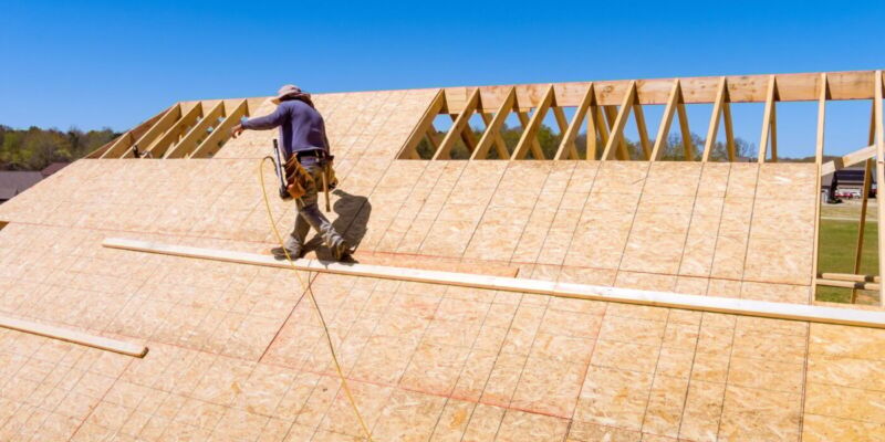 Home roof construction applying roof plywood panels in new house Home roof construction applying roof plywood panels in new house