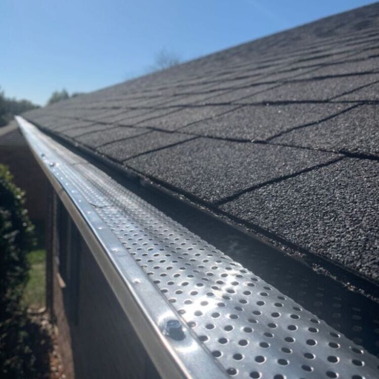 Roof of a house showing gutter and gutter guard protection against leaves Home maintenance